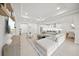 Spacious living room with light gray sofa, recessed lights, and access to kitchen at 7717 Sandhill Lake Dr, Sarasota, FL 34241