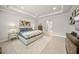 Bright main bedroom featuring a tray ceiling, patterned rug, and neutral color palette at 7717 Sandhill Lake Dr, Sarasota, FL 34241
