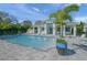 Community pool with patio, featuring steps into the water and manicured potted plant on the brick surface at 7717 Sandhill Lake Dr, Sarasota, FL 34241