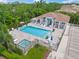Community pool area with plenty of lounge chairs for residents to use with adjacent parking at 7717 Sandhill Lake Dr, Sarasota, FL 34241