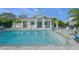 Resort-style community pool with covered lounge area, outdoor seating, and a serene atmosphere at 7717 Sandhill Lake Dr, Sarasota, FL 34241