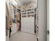 Spacious walk-in closet featuring custom shelving, drawer storage, and shoe racks at 7717 Sandhill Lake Dr, Sarasota, FL 34241