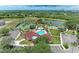 Aerial shot showcases community amenities: pool, playground, tennis and basket ball court and lake at 7885 Bristol Park Dr, Apollo Beach, FL 33572