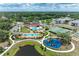 Aerial view showcasing community amenities: pools, playgrounds, sports courts, and green spaces at 7885 Bristol Park Dr, Apollo Beach, FL 33572