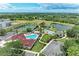 Aerial view of community amenities including pools, playgrounds, sport courts, and green spaces at 7885 Bristol Park Dr, Apollo Beach, FL 33572