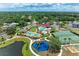 Beautiful aerial view of community amenities including pool, clubhouse, playground, and sports courts at 7885 Bristol Park Dr, Apollo Beach, FL 33572