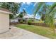 Relaxing backyard with a pond view, complemented by a well-kept lawn and ample patio space at 7885 Bristol Park Dr, Apollo Beach, FL 33572