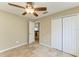 Bedroom featuring closet, ceiling fan, neutral paint and tile flooring at 7885 Bristol Park Dr, Apollo Beach, FL 33572