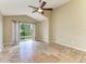 Bedroom with tile flooring, ceiling fan, neutral paint, and sliding door to backyard at 7885 Bristol Park Dr, Apollo Beach, FL 33572