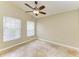 Bedroom with natural light from large window, tiled floors, and neutral paint at 7885 Bristol Park Dr, Apollo Beach, FL 33572