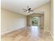 Bright bedroom with a ceiling fan, neutral paint, tile flooring, and sliding door access to the backyard at 7885 Bristol Park Dr, Apollo Beach, FL 33572