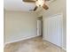 Bedroom featuring closet, ceiling fan, neutral paint and tile flooring at 7885 Bristol Park Dr, Apollo Beach, FL 33572
