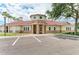 Welcoming clubhouse exterior with stone accents, a well-manicured lawn, and convenient parking spaces at 7885 Bristol Park Dr, Apollo Beach, FL 33572
