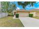 Well-maintained single-Gathering home with a lush green lawn and a two-car garage at 7885 Bristol Park Dr, Apollo Beach, FL 33572