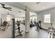 Spacious gym with various exercise machines, ceiling fans, and natural light from multiple windows at 7885 Bristol Park Dr, Apollo Beach, FL 33572