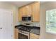 Close-up view of a kitchen featuring modern appliances, granite countertops, and wooden cabinets at 7885 Bristol Park Dr, Apollo Beach, FL 33572