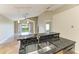 Open kitchen featuring stainless steel appliances and a granite countertop island with a sink at 7885 Bristol Park Dr, Apollo Beach, FL 33572