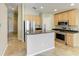 Modern kitchen featuring a center island with granite countertops and stainless steel appliances at 7885 Bristol Park Dr, Apollo Beach, FL 33572