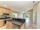 Open kitchen with granite countertops, stainless steel appliances, and a breakfast bar overlooking the living area at 7885 Bristol Park Dr, Apollo Beach, FL 33572