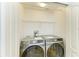 Neat laundry room features a modern Samsung washer and dryer set with wire shelving for storage at 7885 Bristol Park Dr, Apollo Beach, FL 33572