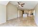 Open-concept living room with tiled floors, neutral walls, and an open kitchen view at 7885 Bristol Park Dr, Apollo Beach, FL 33572
