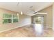 Open living area with tile flooring, a ceiling fan, pendant lights, and a sliding glass door at 7885 Bristol Park Dr, Apollo Beach, FL 33572