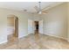 Spacious main bedroom featuring tile flooring, ceiling fan, and ensuite bathroom access at 7885 Bristol Park Dr, Apollo Beach, FL 33572