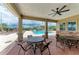 Covered patio with tables and chairs overlooking the inviting community pool at 7885 Bristol Park Dr, Apollo Beach, FL 33572