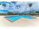 A refreshing community pool featuring comfortable lounge chairs and shady umbrellas at 7885 Bristol Park Dr, Apollo Beach, FL 33572