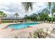 Inviting community pool with lounge chairs and lush greenery, perfect for relaxation at 7885 Bristol Park Dr, Apollo Beach, FL 33572