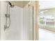Modern shower with tiled walls and glass door in a well-lit bathroom at 7885 Bristol Park Dr, Apollo Beach, FL 33572