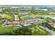 Aerial view showcasing the community's pool, clubhouse, tennis courts, golf course, and surrounding homes at 7911 Grand Estuary Trl # 201, Bradenton, FL 34212