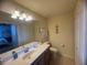 Bathroom featuring a vanity with sink, a toilet, and a large mirror at 7911 Grand Estuary Trl # 201, Bradenton, FL 34212