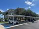 Assigned parking under carport with a white SUV parked, showcasing convenient resident parking at 7911 Grand Estuary Trl # 201, Bradenton, FL 34212