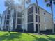 Multi-story condo building with screened lanais and lush landscaping offering tropical living at 7911 Grand Estuary Trl # 201, Bradenton, FL 34212