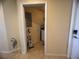 Bright laundry room with a washer, a dryer, and storage shelves at 7911 Grand Estuary Trl # 201, Bradenton, FL 34212