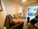 Comfortable living room with a couch, a love seat, and view into the dining area at 7911 Grand Estuary Trl # 201, Bradenton, FL 34212