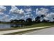Scenic view of a tranquil pond surrounded by lush greenery under a partly cloudy sky at 7911 Grand Estuary Trl # 201, Bradenton, FL 34212