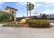 Community tennis center featuring a giant tennis ball and tropical landscaping creating a vibrant atmosphere at 7911 Grand Estuary Trl # 201, Bradenton, FL 34212