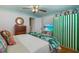 Cozy bedroom featuring hardwood floors, a dresser, TV and fun decorations for a tranquil retreat at 8 Desoto E St, Bradenton, FL 34208
