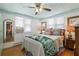 Comfortable bedroom with a tropical-themed bedspread, white walls, and natural light from the window at 8 Desoto E St, Bradenton, FL 34208