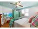 Cozy bedroom with bright, patterned walls, natural lighting, and a tropical-themed bedspread at 8 Desoto E St, Bradenton, FL 34208