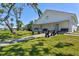 Community clubhouse with benches and mature trees with manicured lawn at 8 Desoto E St, Bradenton, FL 34208