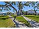 Community buildings with sidewalks and manicured lawn with picnic tables at 8 Desoto E St, Bradenton, FL 34208