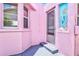 Side entryway of a charming pink house featuring a mermaid-themed accent at 8 Desoto E St, Bradenton, FL 34208