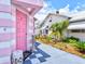 Charming pink front door entrance with a unique design and landscaped surroundings at 8 Desoto E St, Bradenton, FL 34208