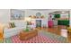 Cozy living room showcasing a white sofa, fireplace and colorful kitchen beyond at 8 Desoto E St, Bradenton, FL 34208