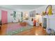 Living room with hardwood floors, eclectic rug, fireplace and charming tropical decor at 8 Desoto E St, Bradenton, FL 34208