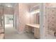 The spacious bathroom features floral wallpaper and a vanity with a large mirror and ample lighting at 8 Dominica Dr, Englewood, FL 34223