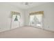 Bright bedroom with carpet, French doors, and decorative window curtains at 8 Dominica Dr, Englewood, FL 34223